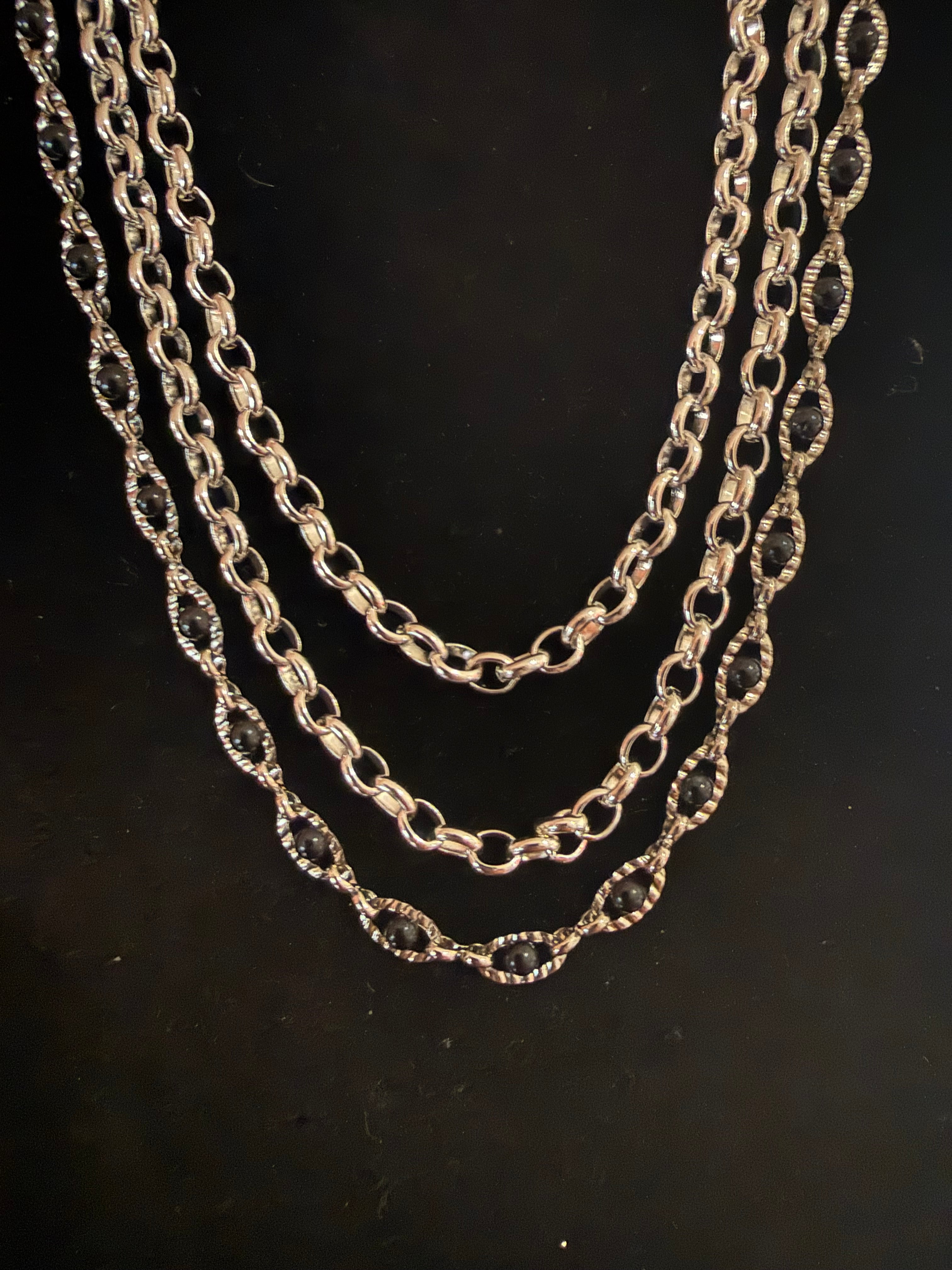 3 strand silver necklace with black beads and earrings