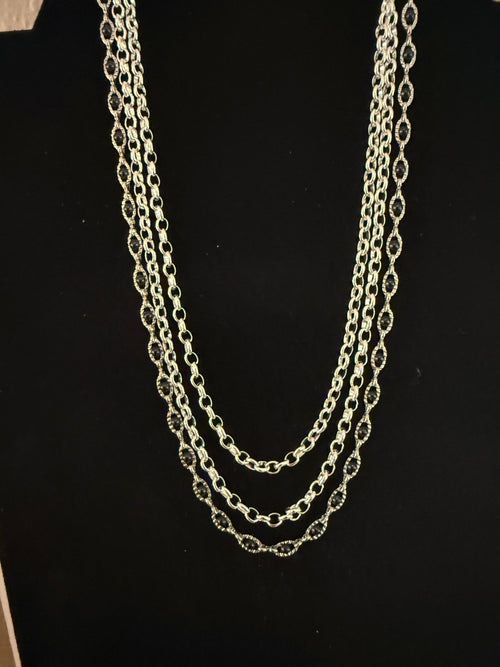 3 strand silver necklace with black beads and earrings