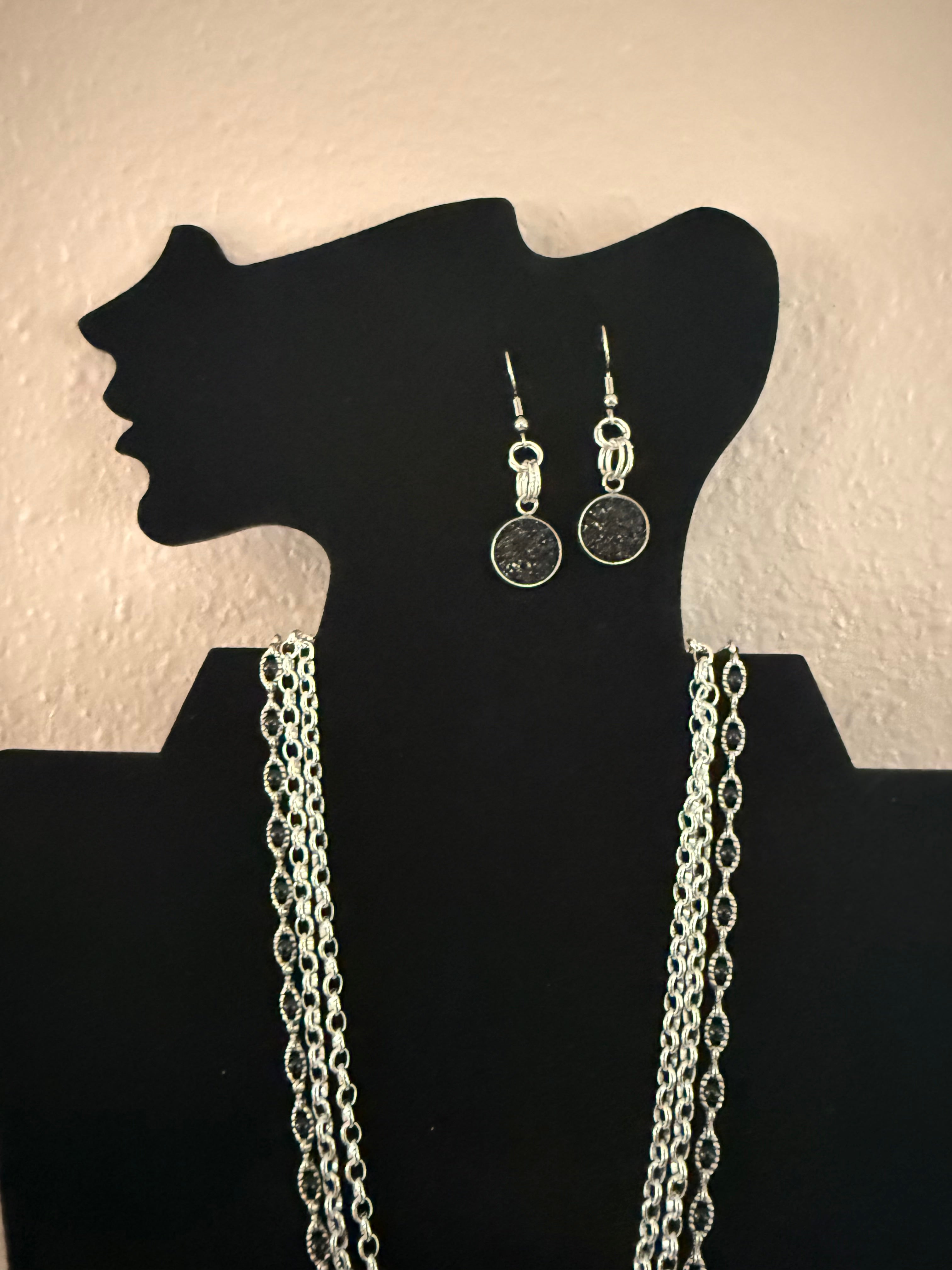 3 strand silver necklace with black beads and earrings